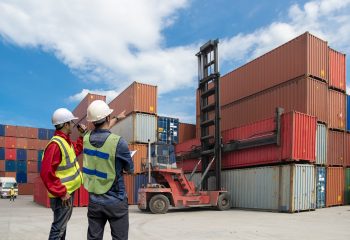 Foreman control loading Containers box to truck for Logistic Import Export Background, Business logistic concept, import and export concept.