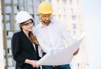 smiling-man-woman-looking-blueprint