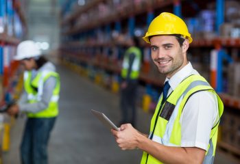 Portrait of warehouse manager holding digital tablet in warehouse