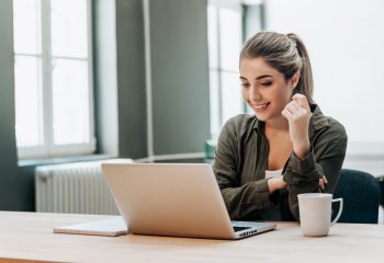 Attentive woman watching media in a laptop.